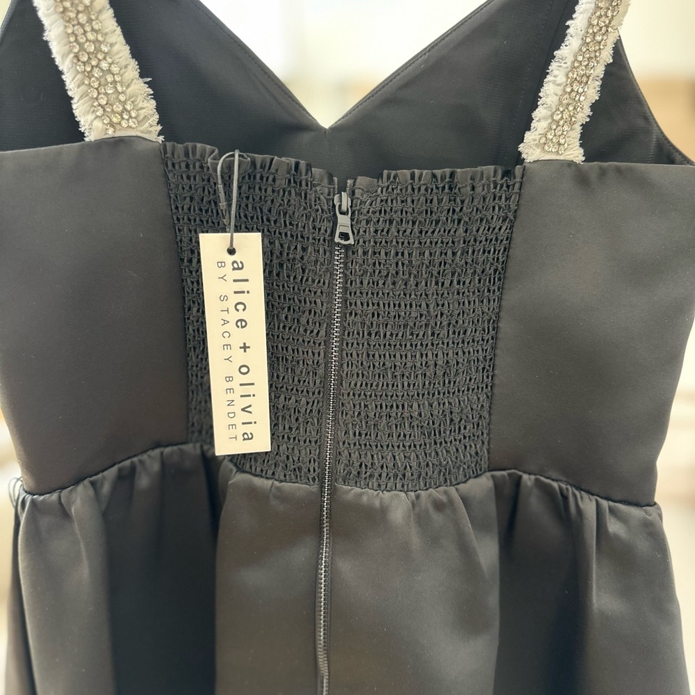 Black stain with some stones on the shoulder straps; very classy; never used.